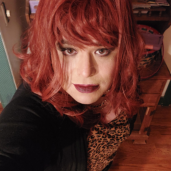 MIstress Ilya is looking up into her camera.