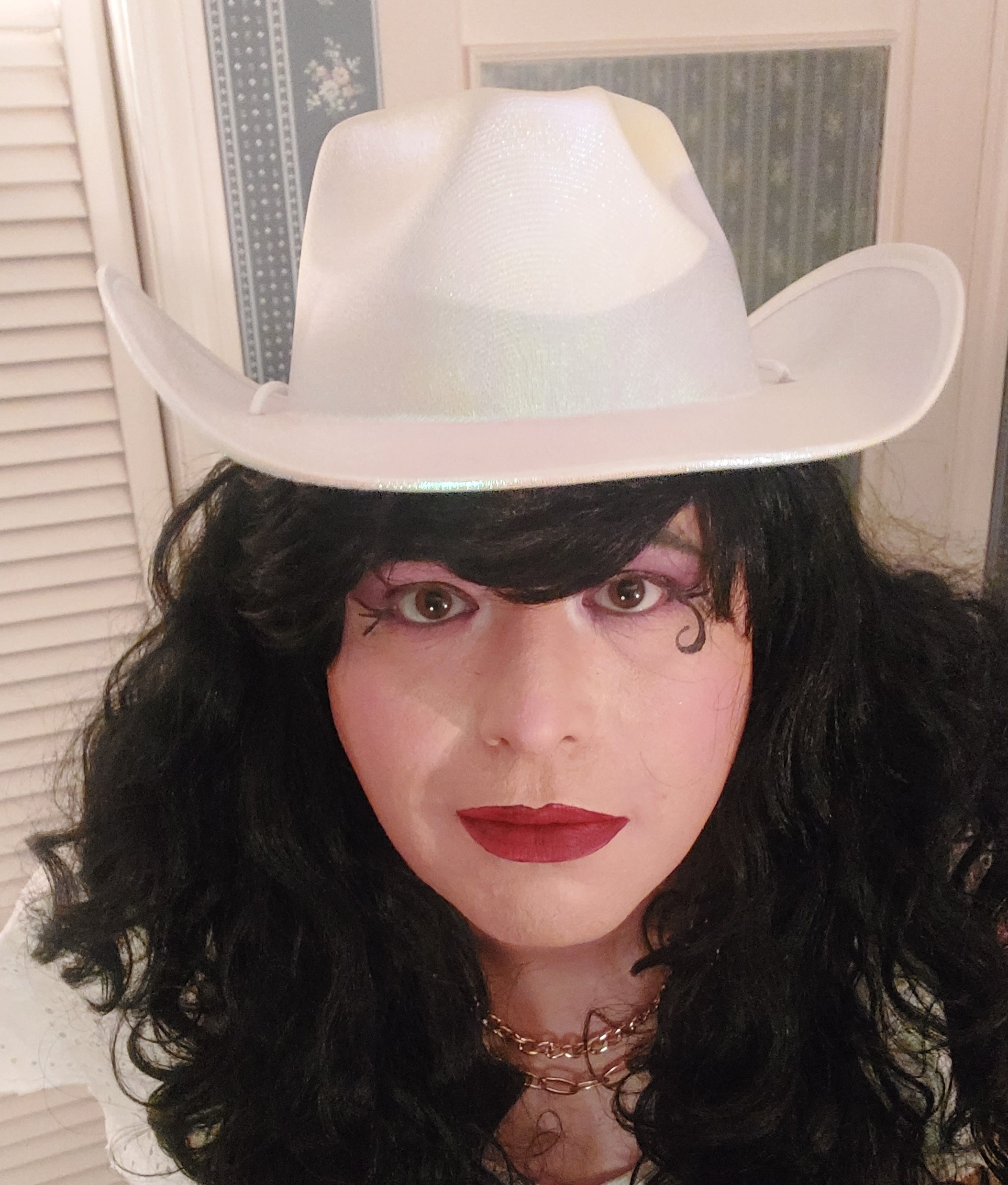 Mistress is wearing a cowboy hat.