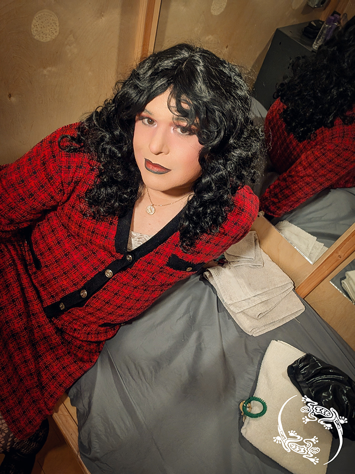 Mistress Ilya is laying on a bed in a room at Hawks PDX.