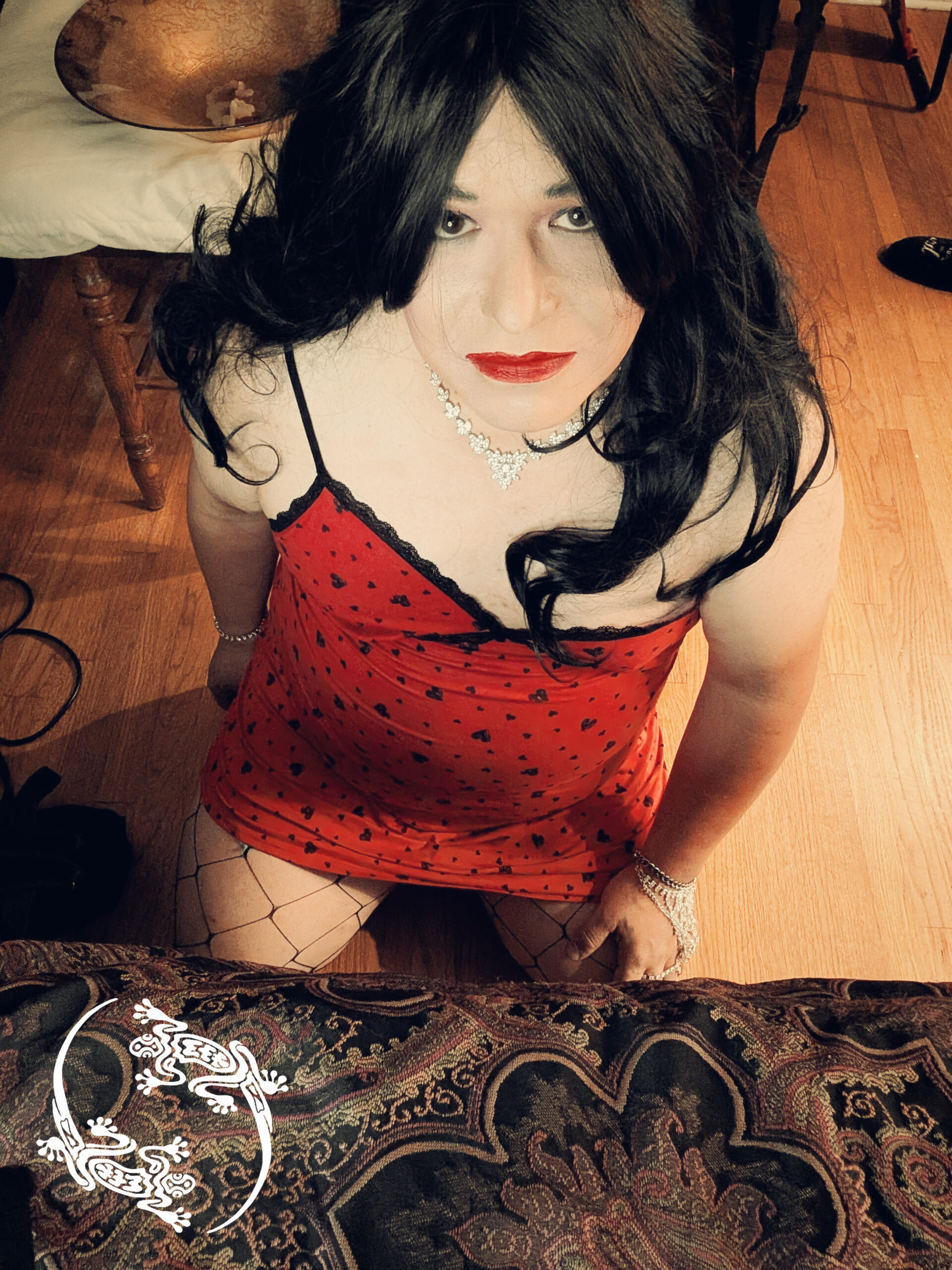 Mistress Ilya is on her knees on a floor.