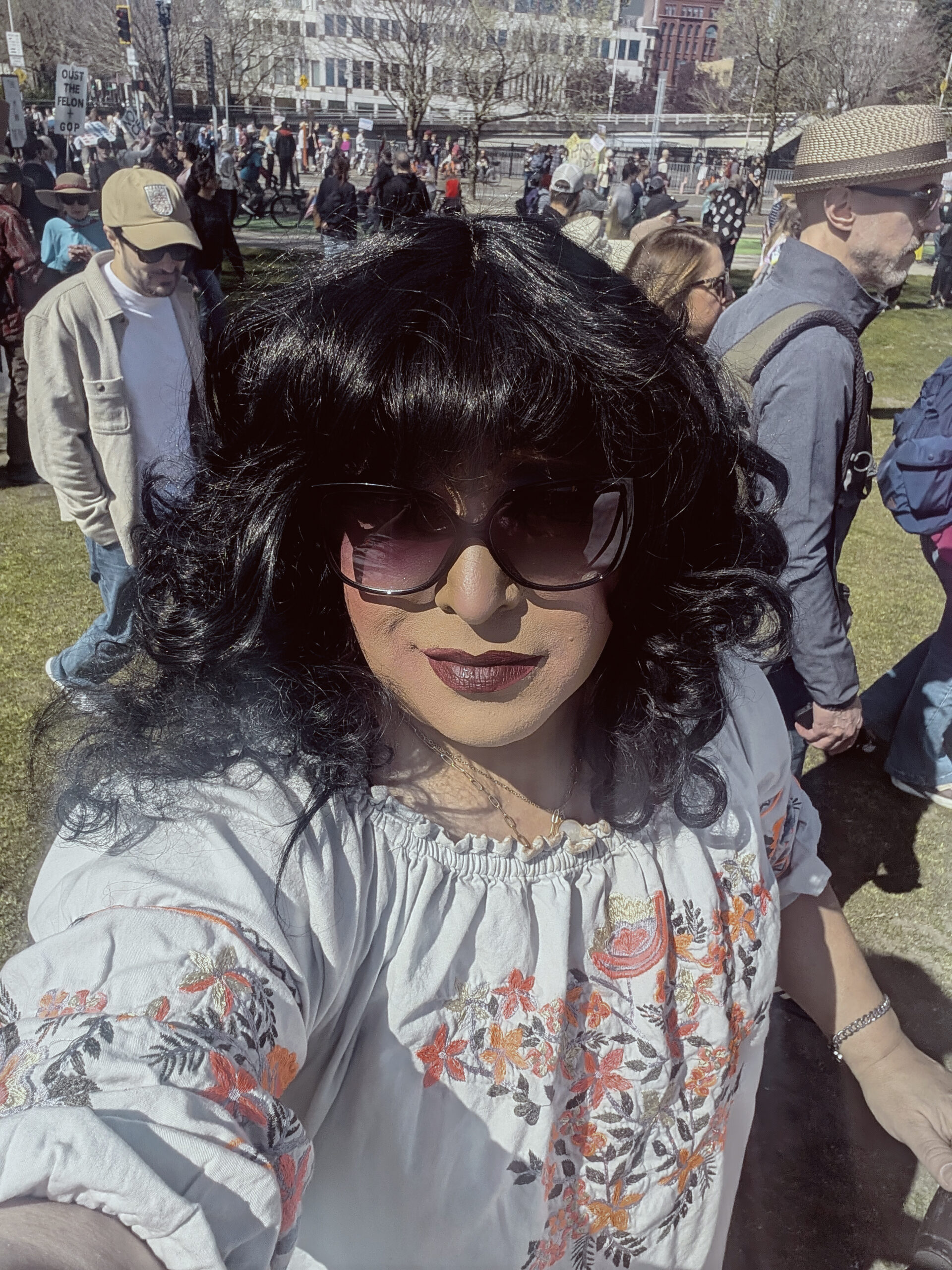 Mistress Ilya is at the Waterfront Park wearing sunglasses.
