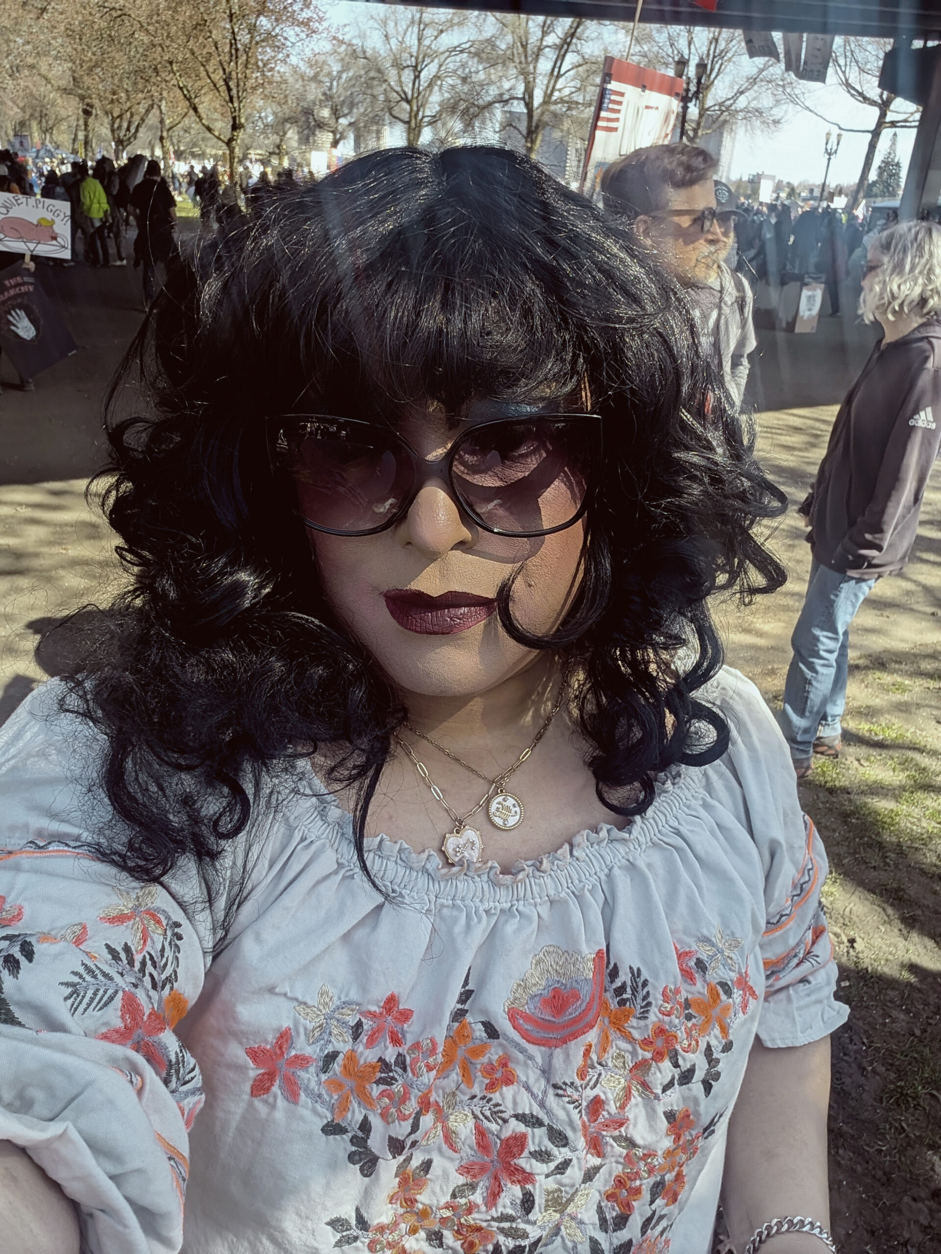 Mistress Ilya is at the Waterfront Park wearing sunglasses.
