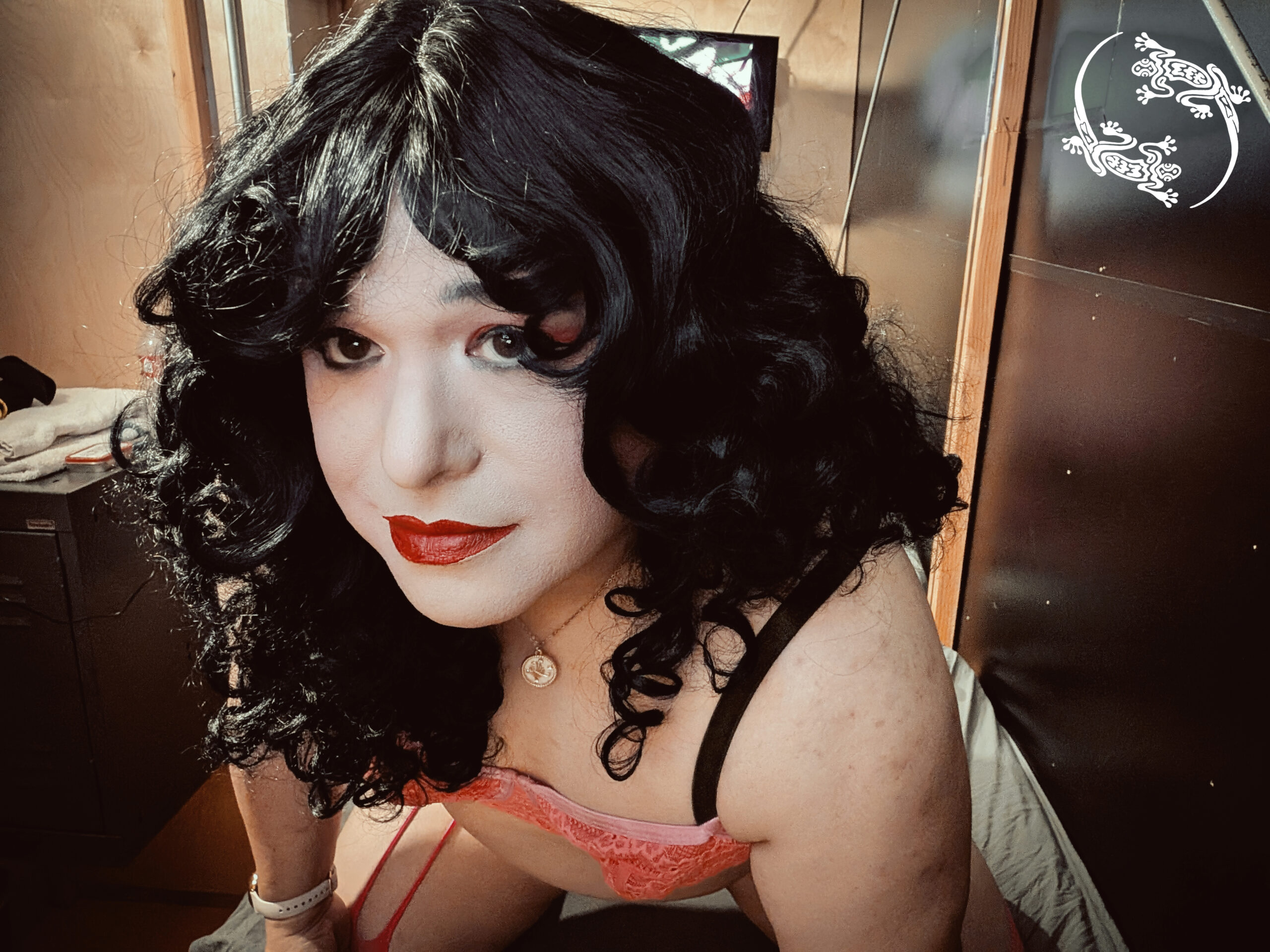 Mistress Ilya is looking into the camera with her head tilted.