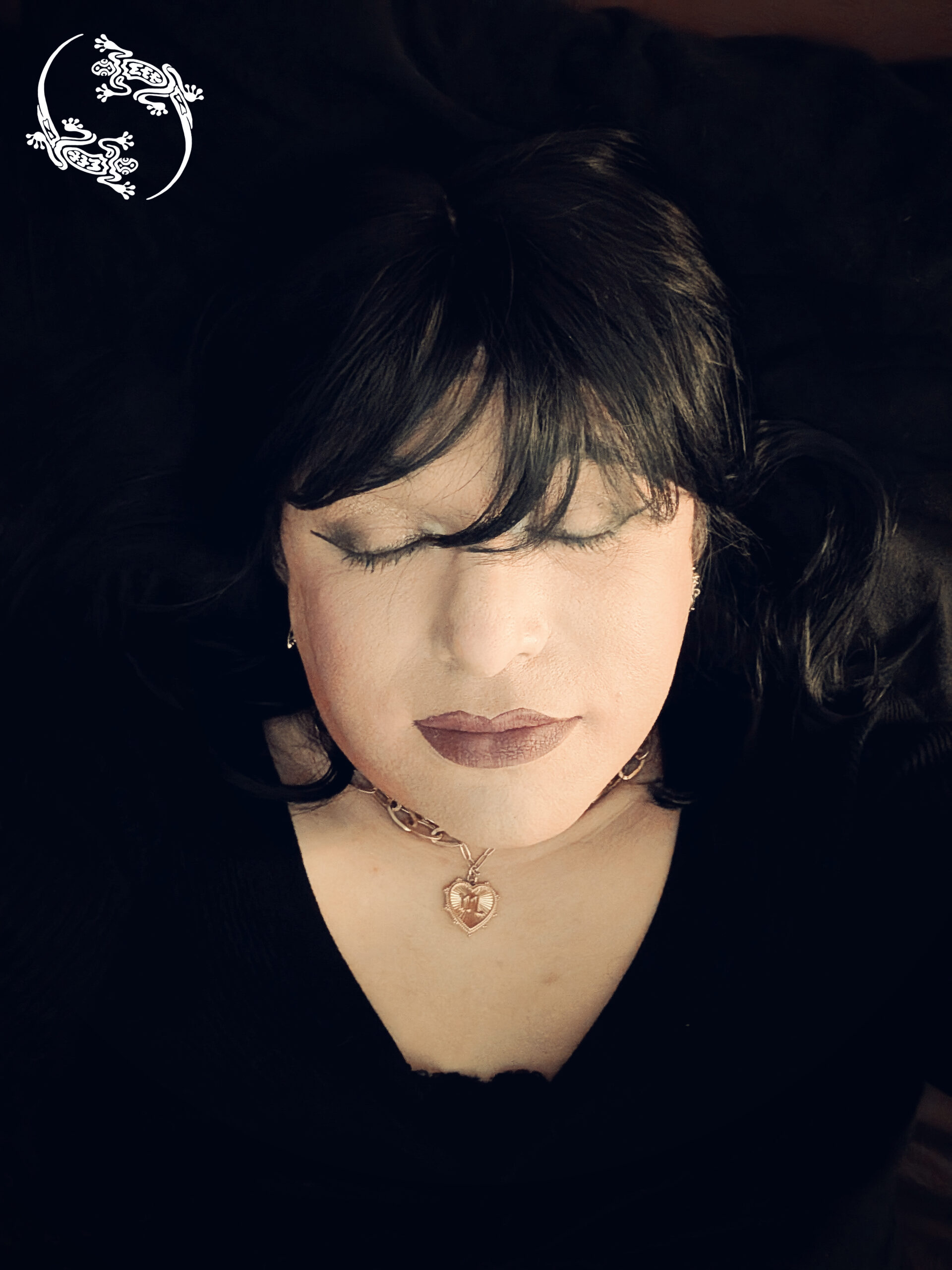 Mistress Ilya has her eyes close while taking a picture.