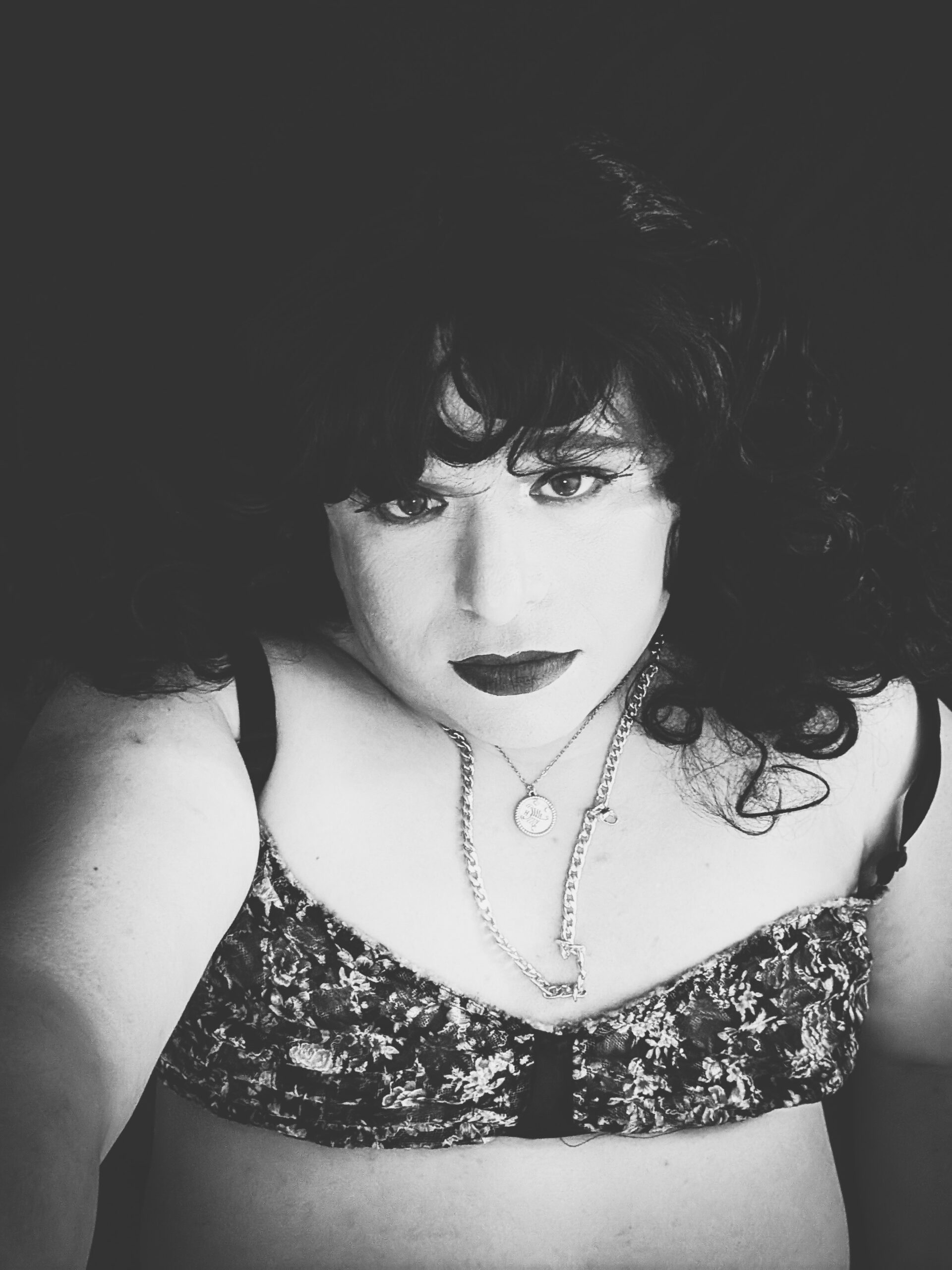 Mistress Ilya is looking into the camera. 