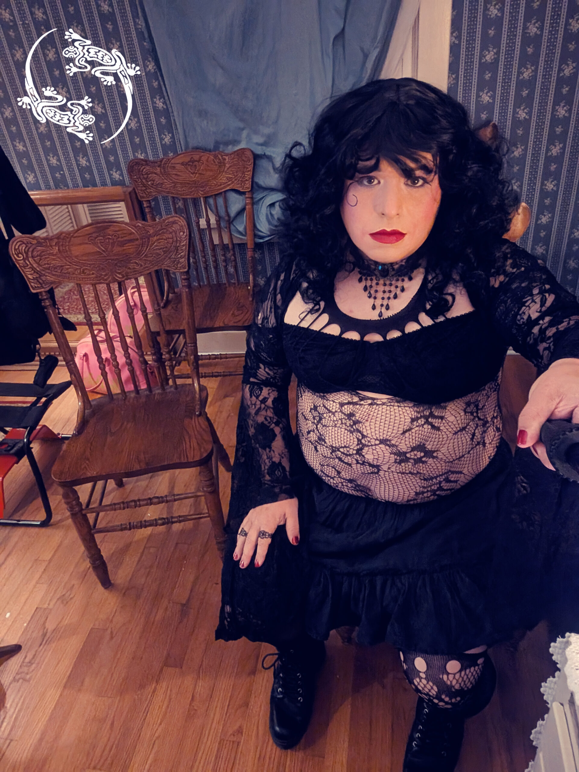 Mistress Ilya is sitting on a chair among many chairs.