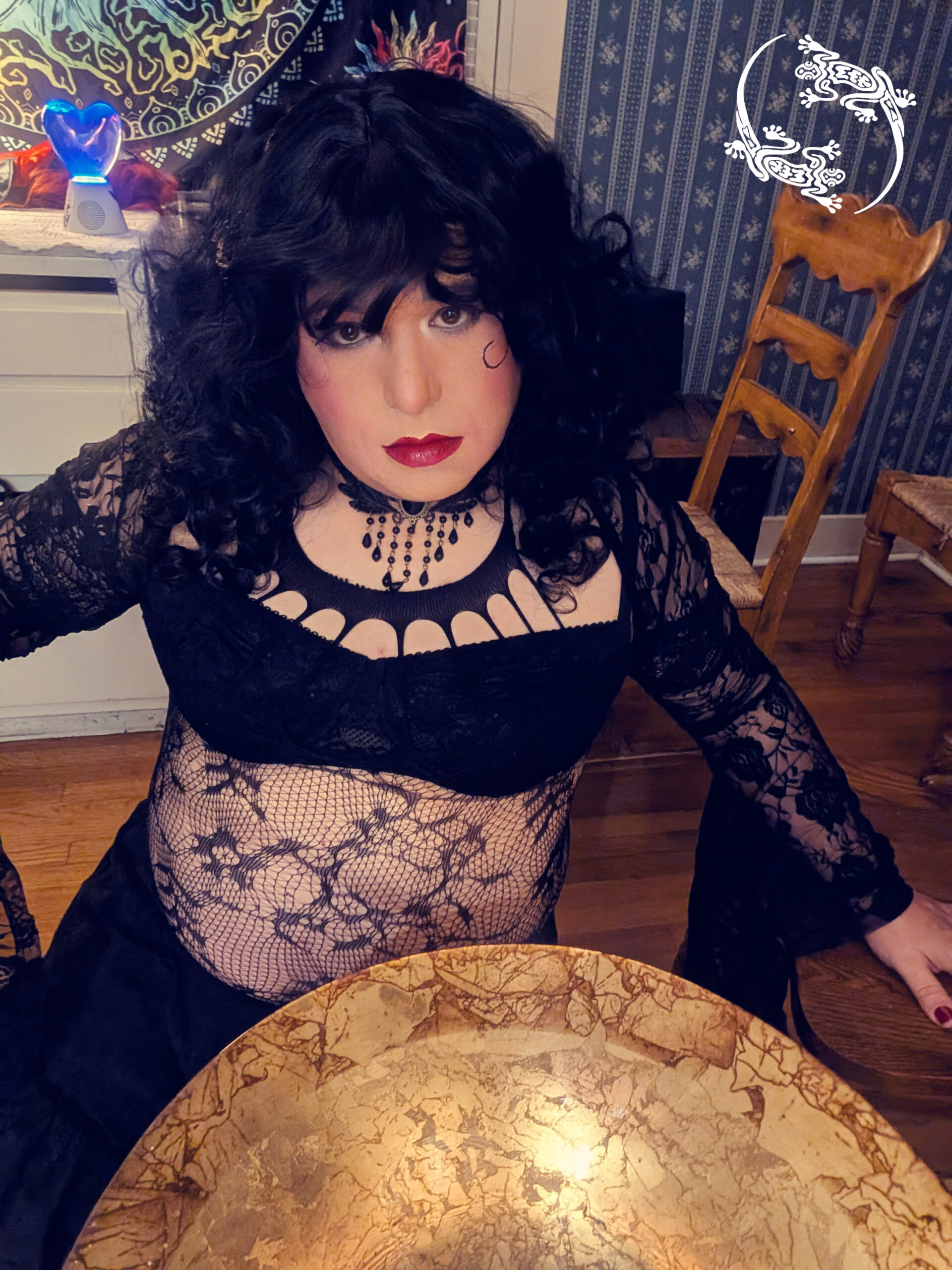 Mistress Ilya is sitting in front of her gold altar plate.