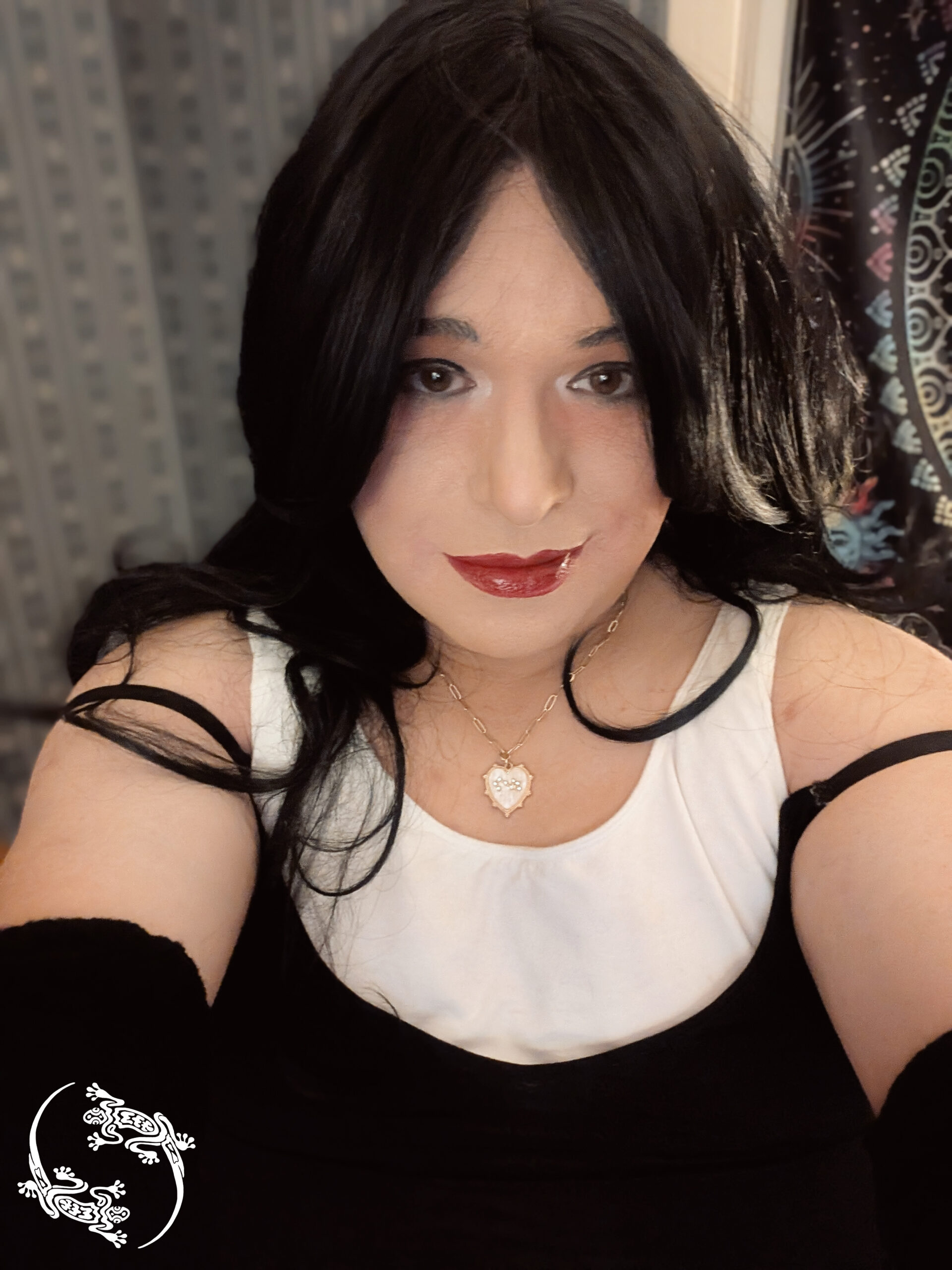 Mistress Ilya has taken a picture of herself. she is smiling.