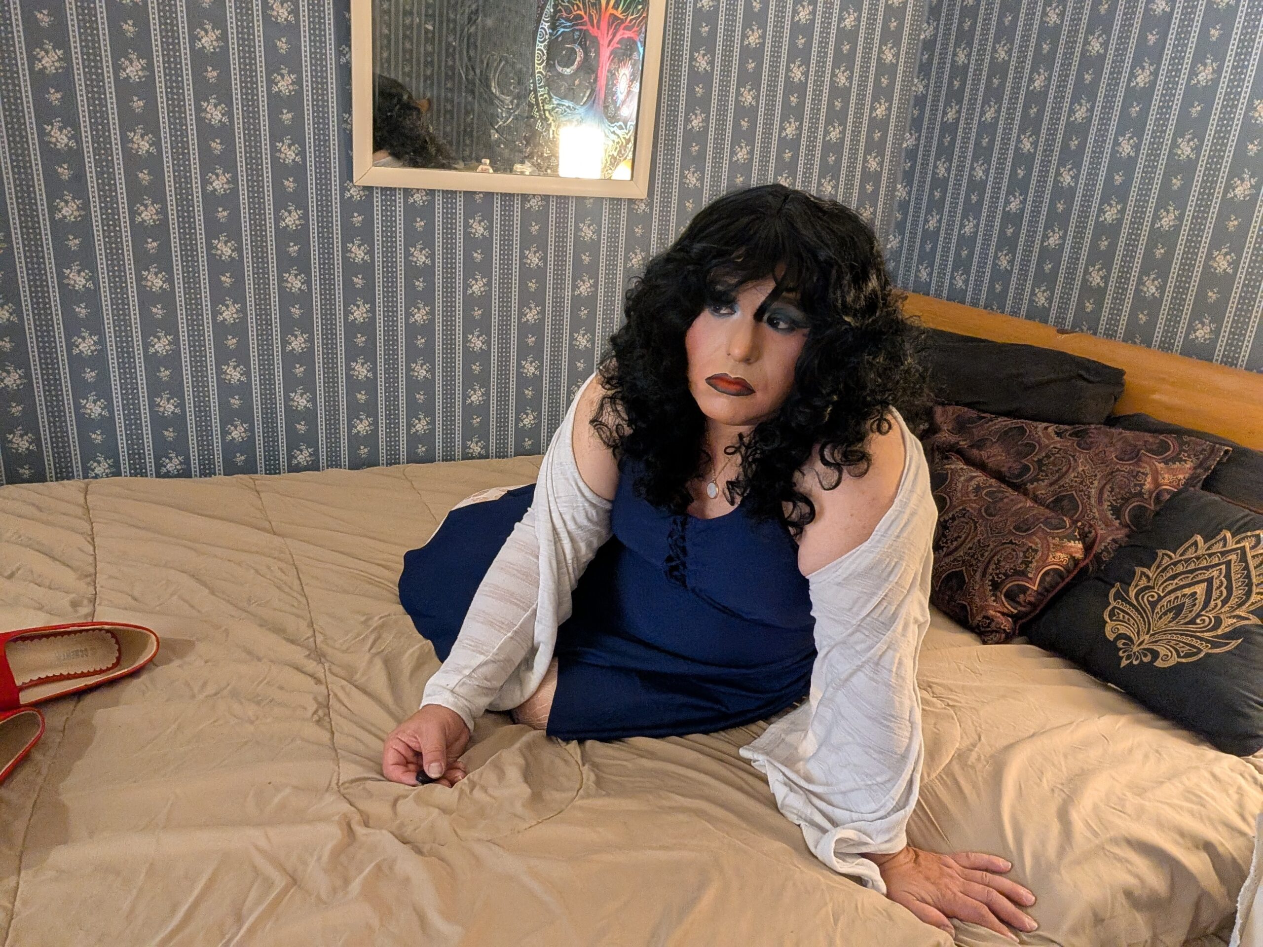 Mistress Ilya is laying on her bed looking into the camera.