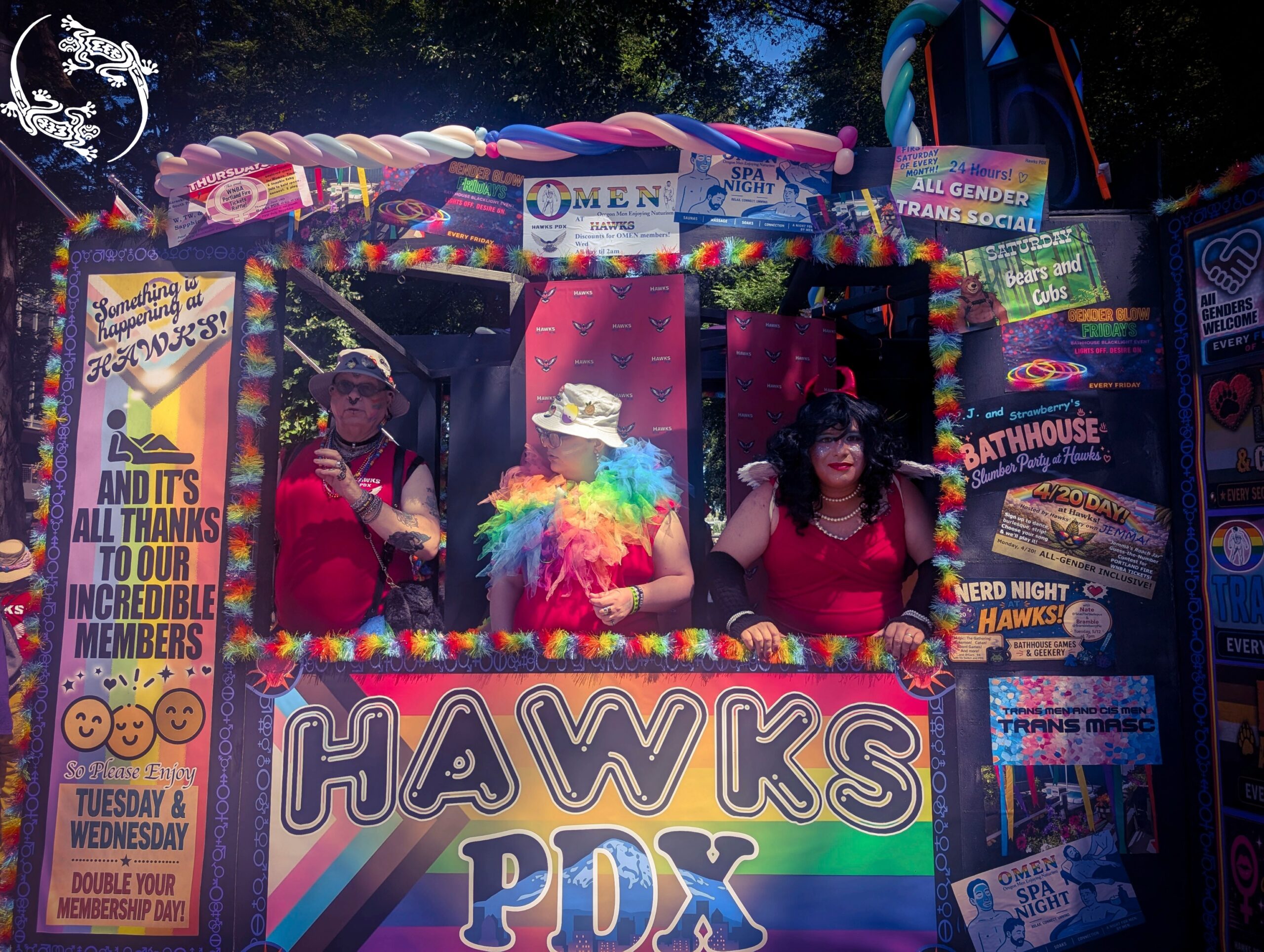 Mistress Ilya and other people are standing in a poster clad cart featuring the text Hawks PDX.