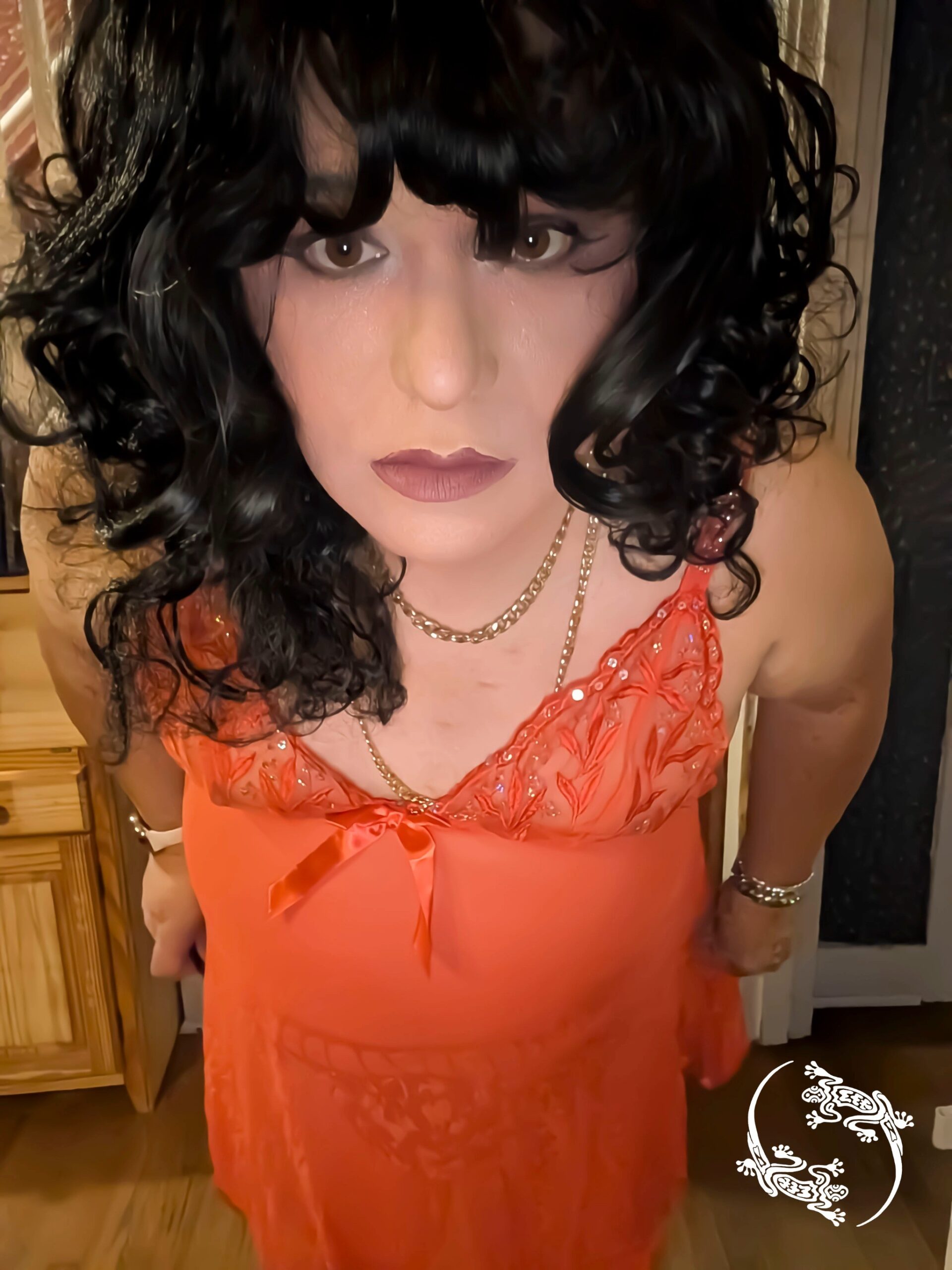 Mistress Ilya is wearing a lacy teddy and looking into the camera.
